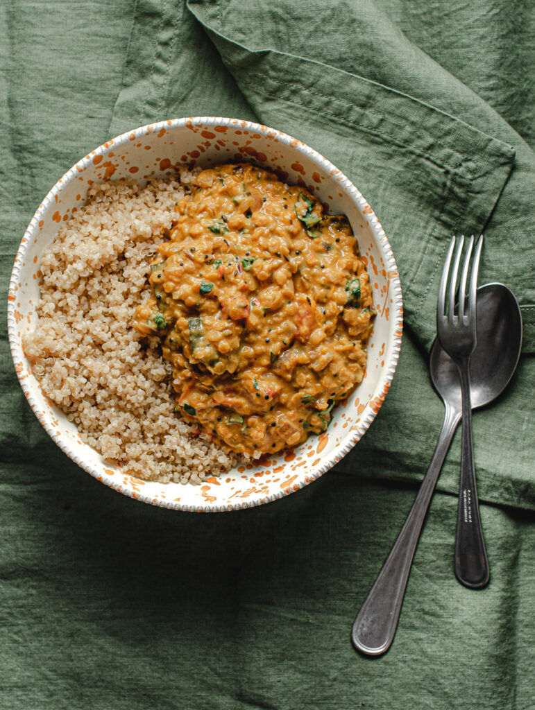 Dahl made from butternut squash in a bowl with a side of quinoa